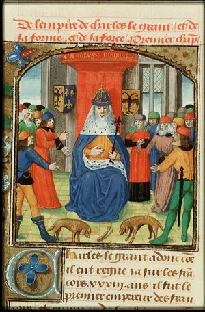 Charlemagne and his court, looking at a scene of two dogs facing each other over a bone