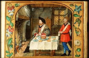 January: a man dining and warming himself at a fire