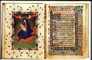 Madonna: Mary sitting on the ground, holding the Christ-child, is crowned by two angels