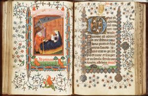 The Nativity: Mary lies in bed holding the Christ-child, St. Joseph offers a meal