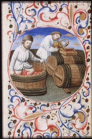 September: two men making wine, one of them treads grapes