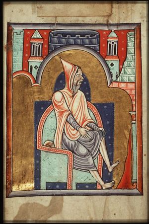 February: a man warming himself at a fire