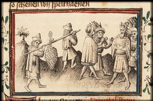The spies return from Canaan carrying a large bunch of grapes