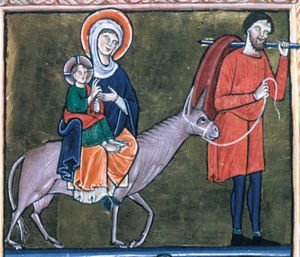 Joseph, carrying a stick with a cloth over it, leads the ass; Mary rides the ass, supporting with her covered right hand the Christ-child, while holding her left hand in front of her chest; the child stretches his right arm forward in blessing and holds a closed scroll in his left.