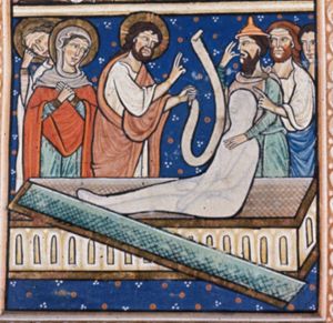 Christ, holding a scroll in his left, stretches his right hand forward in a speaking gesture to Lazarus, who sits in a sarcophagus, completely wrapped in a shroud, and who is supported by a man with a Jew-hat, who has bent his hand to his head; two men stand behind him, one of whom points at Christ with his left hand forward; behind Christ: Mary and Martha, the first wringing her hands, the other with her hand against her head.