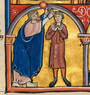 Samuel holds a ointment-jar with his left hand above Saul's head and touches his head with his right; Saul, wearing a shorter tunic, holds his hands in front of his chest with palms in front view, in orans posture; architectural setting.