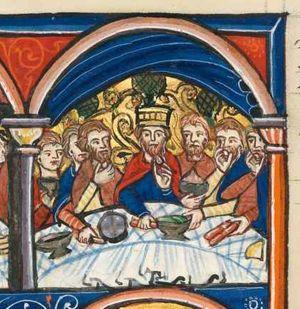 king Ahasuerus is seated behind a sigma-shaped table, amidst the people of Susa; he brings a piece of food to his mouth with his left hand, while holding a bread-roll(?) with his right hand forward; some of the people also bring food to their mouth; two are holding a cup in front of their chest; several also take food from the table with their hand held forward; dishes, bread and bread-rolls(?) on the table; architectural setting with velum.