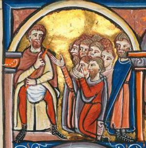 Haman is standing with his legs apart, wearing hoses(?); he is holding a staff in his left, held down across his abdomen; he is making a gesture of speech with his right in front of his chest; a group of people is kneeling on both knees, one man raises his arms, palms of the hands towards each other; Mordecai walks away to the right, turning his head back to his right, looking at Haman.