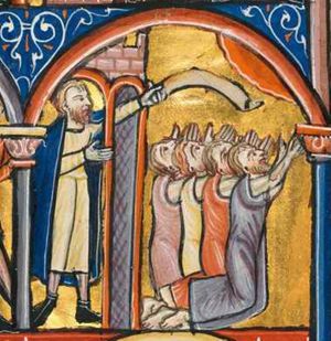 Mordechai is standing under the arcade of a crenellated building, with his right hand forward and his left raised, holding a scroll above the heads of a group of Israelites, who all are kneeling on both knees and who stretch their hands upwards with the palms towards each other, they all turn their head backwards, looking up at heaven; architectural setting.