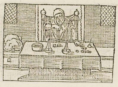 A man seated at a table with a pair of scales and coins