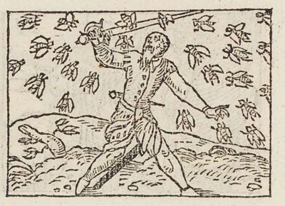 A man holding up a sword smeared with honey, surrounded by flies