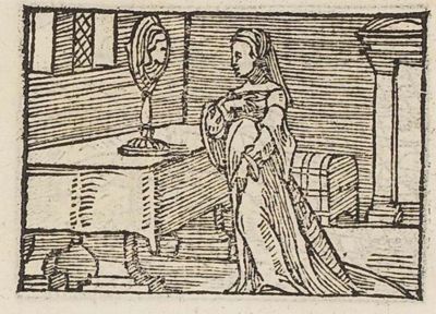 A lady looking at herself in a standing mirror on a table