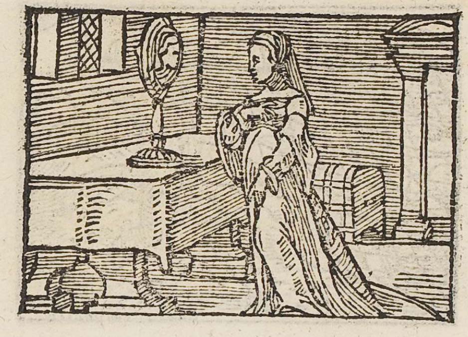 A lady looking at herself in a standing mirror on a table