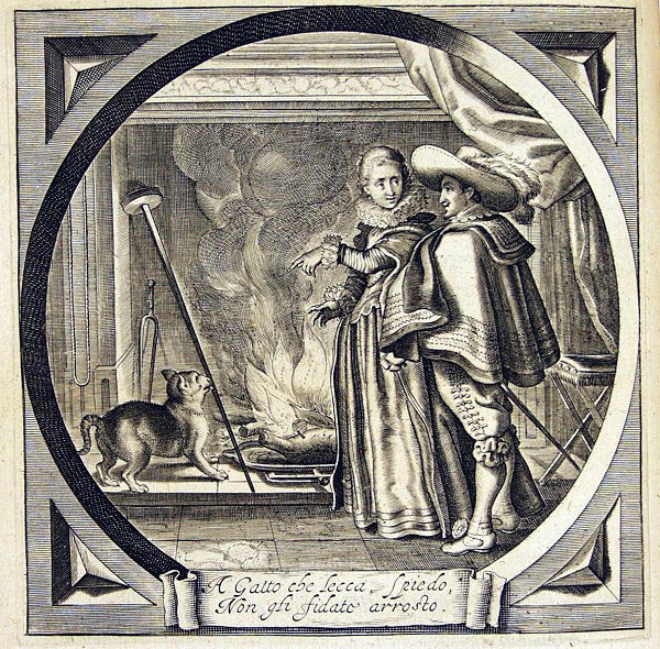 A woman is addressing the man next to her while she is pointing at a cat that licks a spit