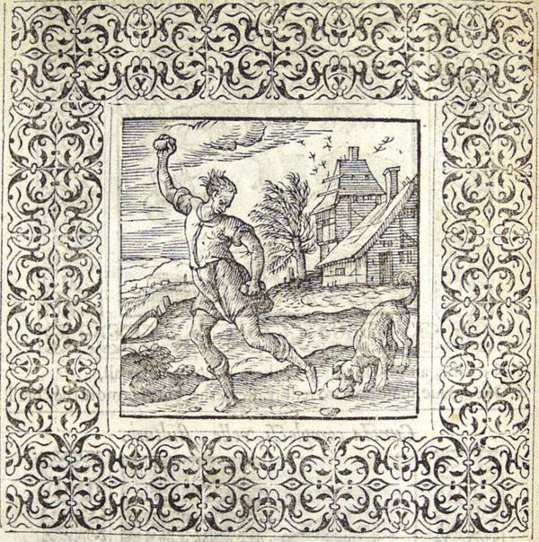 A dog attacks the stone that was thrown at it by the man who raises his hand to throw another