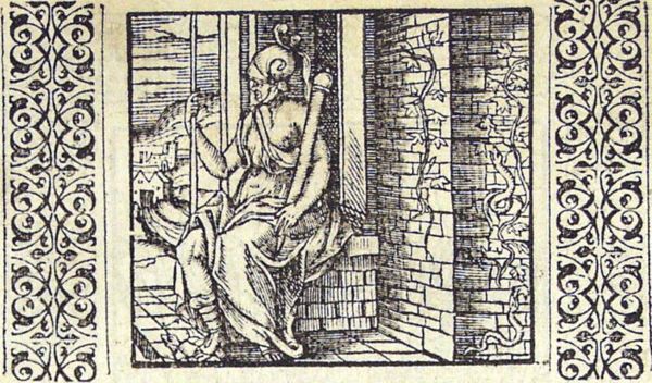 Ivy - with snakes crawling through it - is growing on the wall of a building in front of which Virtue is sitting